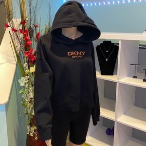 DKNY Sport black hoodie with orange detailed logo motif.